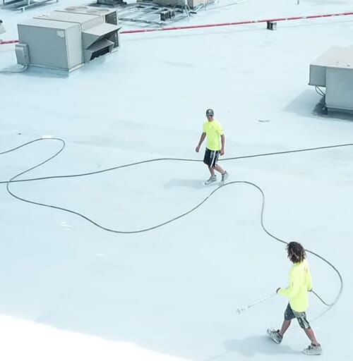 Contractors work on a roof restoration.