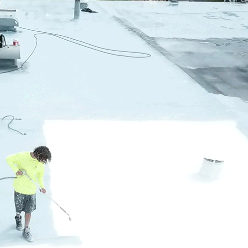 Contractors work on commercial roof restoration.