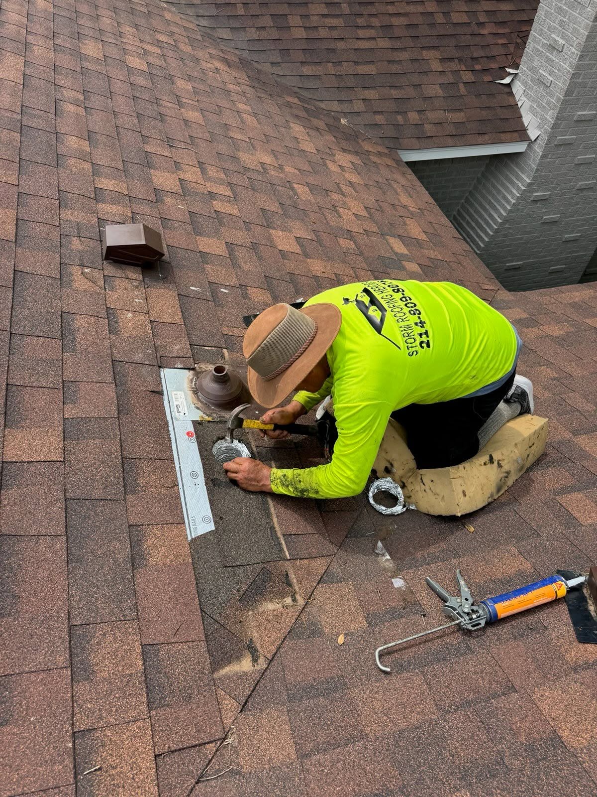 Roofer repairs vent.