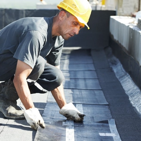 A constractor works on modified bitumen.