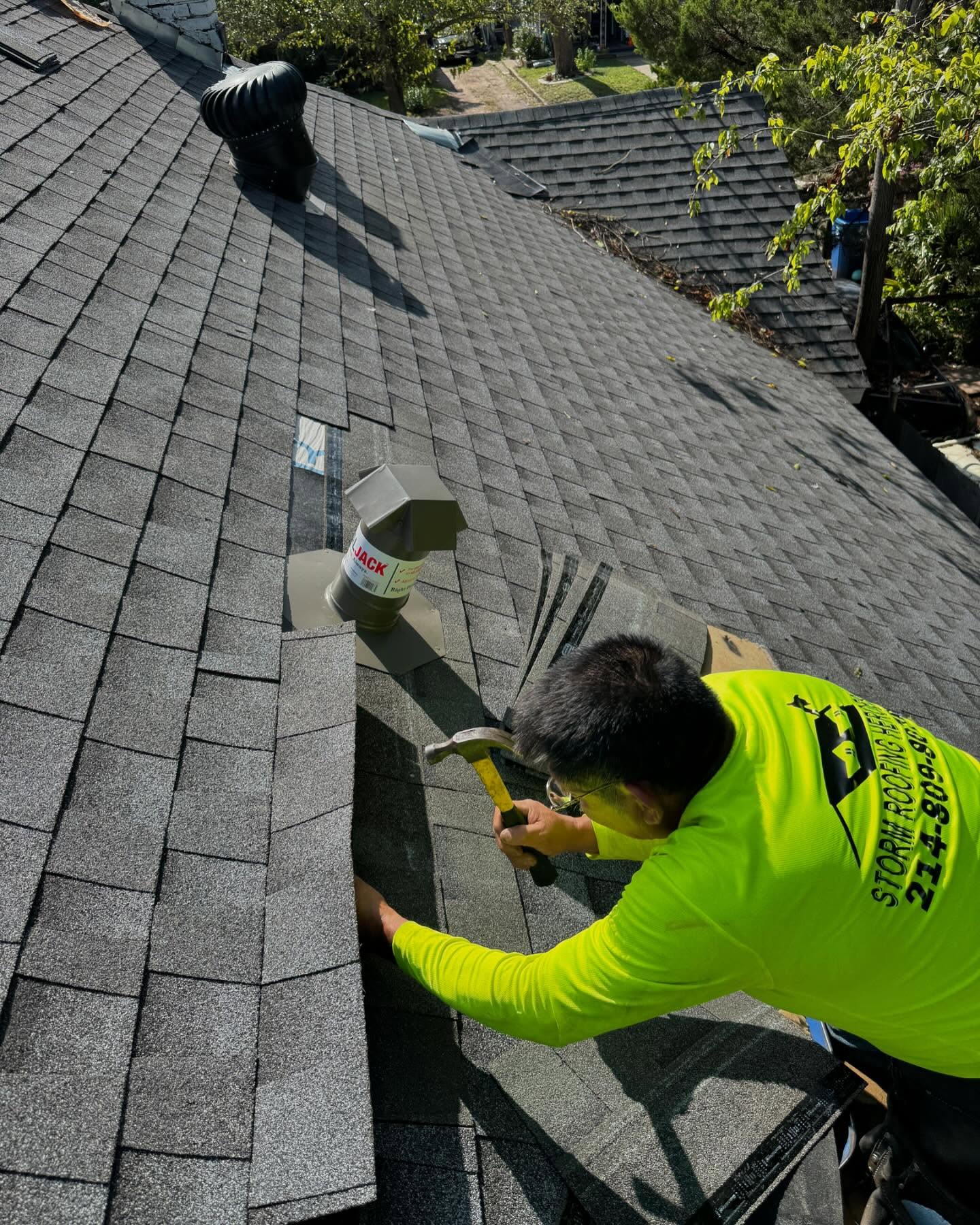 Roofer nails in shingles