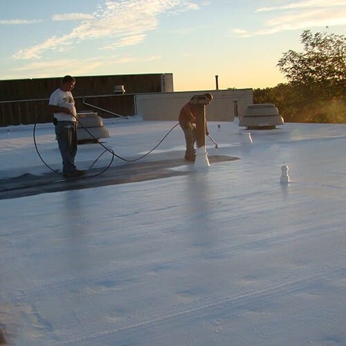 Roofers coat rubber roof.