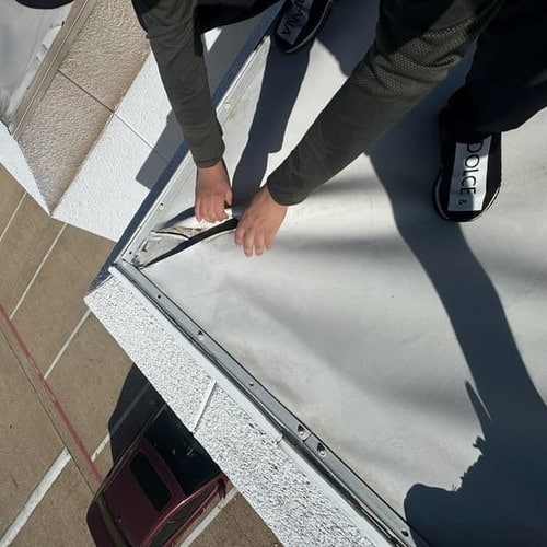 roofer works on commercial roof repair.