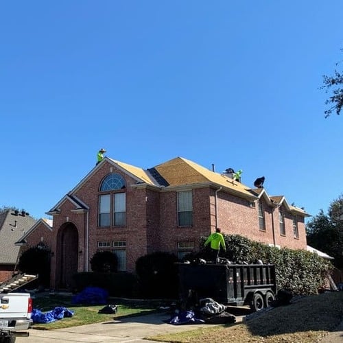 Contractors install a roof.