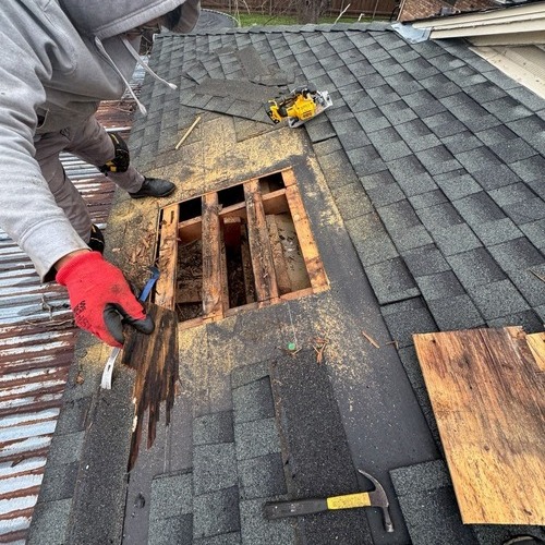 Roofer repairs roof leak.