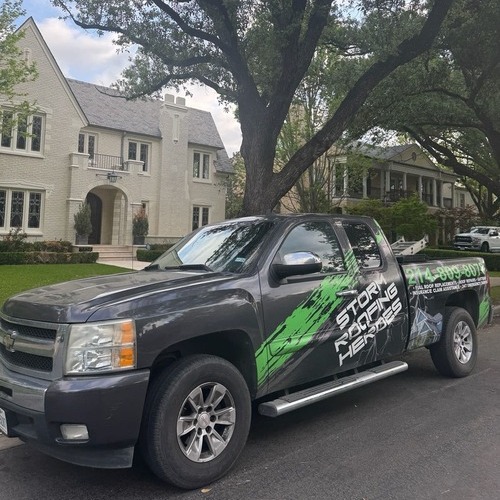 Storm Roofing truck outside of a home.