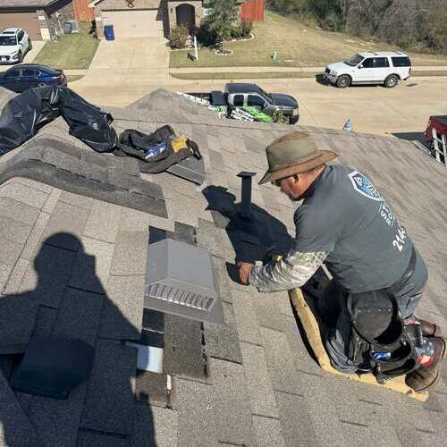 Roofer repairs roof.